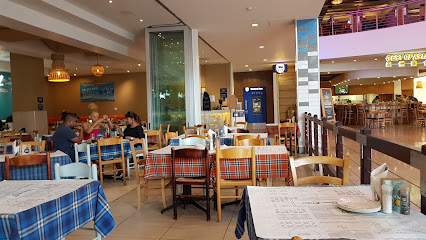 Ocean Basket Cape Gate dining area with checkered tablecloths and seated patrons