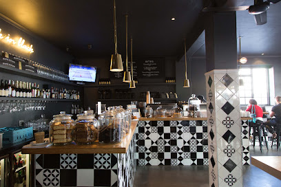 Bootlegger XS Sea Point cafe counter with pastry jars, tiled front and seating