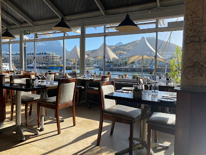 Den Anker dining room with tables facing V&A Waterfront and Table Mountain