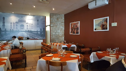 Moksh Restaurant Durbanville dining room with set tables and Taj Mahal mural