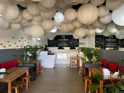 Sushi Box Kloof Street interior with hanging paper lanterns, wooden tables and counter