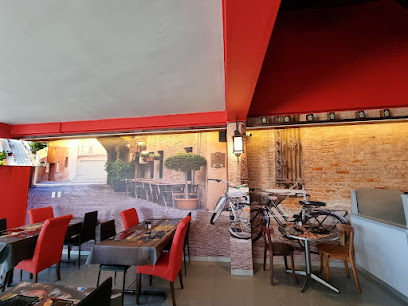 Paulo’s Pizza Parklands dining area with red chairs and bicycle wall mural