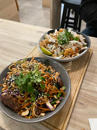 Two Noodle Box Kloof Street noodle bowls with grilled meat, noodles and fresh garnishes