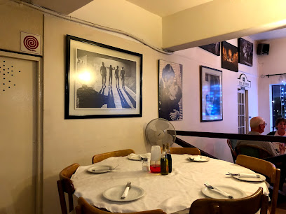 Cafe Pescado dining table set with plates, condiments, and framed photos