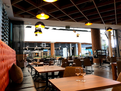 Blu’s Bistro interior with modern dining tables, pendant lights and wine glasses