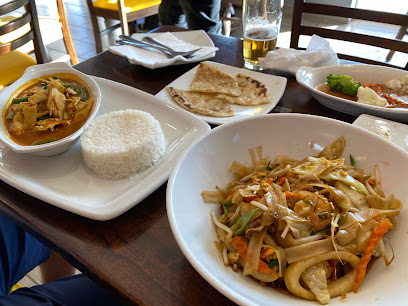 Simply Asia Hout Bay table with Thai curry, steamed rice, stir-fried noodles and roti
