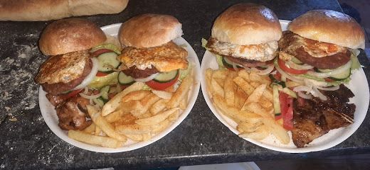Two KwaNdaba Chicken and Chips plates with chicken burgers, fries, and salad