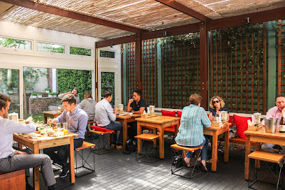 Sushi Box Newlands outdoor dining area with customers at wooden tables