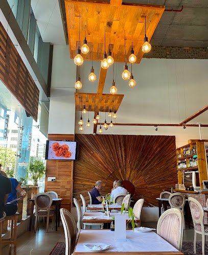 Aiko Sushi Bree Street dining room with wooden pendant lights and set tables