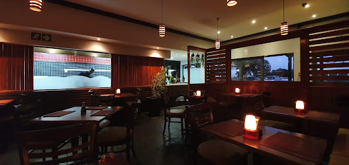 Mai Thai Sushi Lakeside interior with wooden booths, pendant lights and glowing table lamps