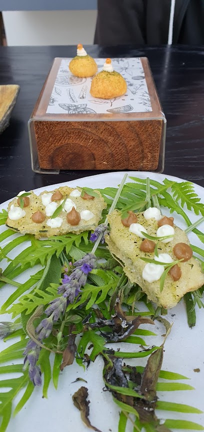 The Greenhouse at The Cellars‑Hohenort starter: herb crisps with cream, brown pearls and fresh herbs