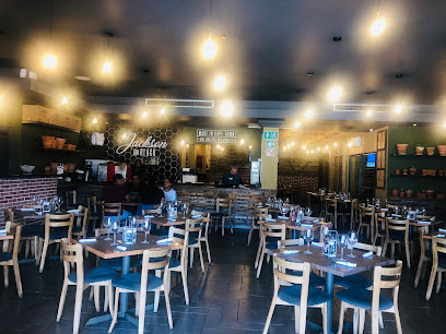 Bossa Burgundy dining room with wooden tables, chairs and warm hanging lights
