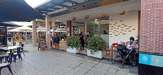 Sushi Box Willowbridge storefront with outdoor seating and fish wall mural