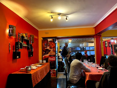 Mzansi Restaurant interior with diners and live saxophonist