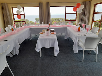 Simon's Town Country Club dining room set for celebration with balloons and sea view