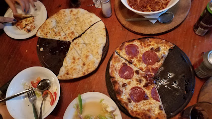 Borruso's partially eaten pepperoni and cheese pizzas on wooden table with pasta