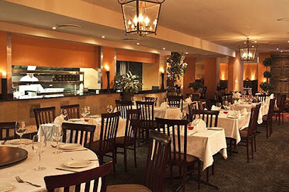 Bihari dining room with white-tablecloth tables and warm lantern lighting