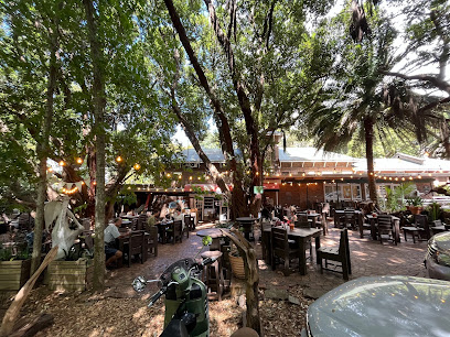 Outdoor shaded dining area at Picnic Cafe and Deli with wooden tables