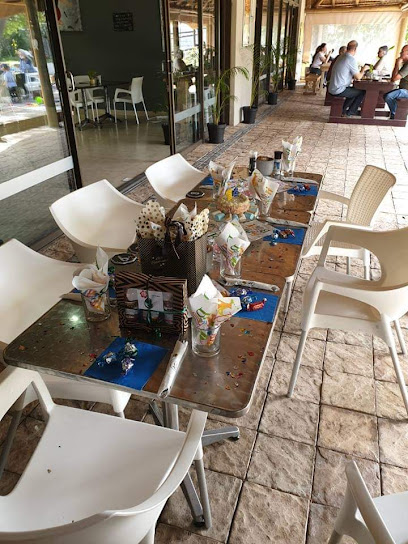 Patio table at Reach Café set with glasses, napkin baskets and placemats
