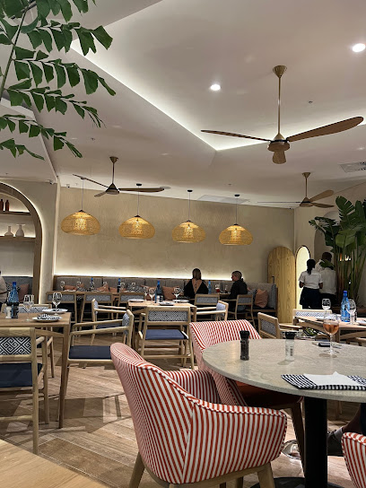 Mythos Greek V&A Waterfront dining room with tables and pendant lighting