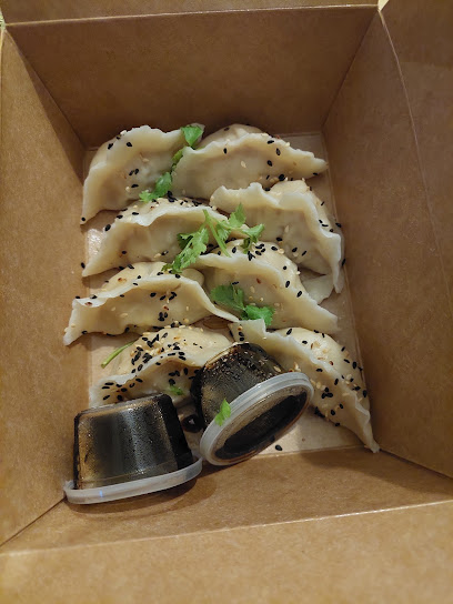 One Bite Dim Sum steamed dumplings with black sesame and cilantro in takeout box