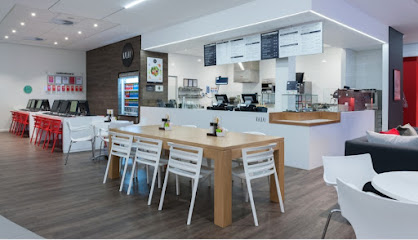 Kauai Virgin Active Sun Valley café interior with service counter, menu boards and communal table