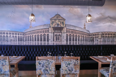 Damascus Restaurant dining area with mural of Damascus architecture