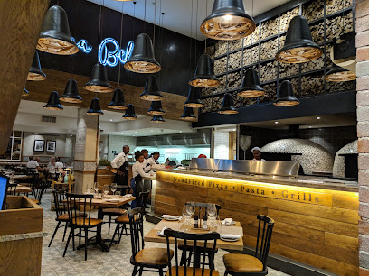 Casa Bella GrandWest dining room with wood-fired pizza oven and servers