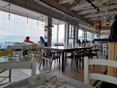 Ocean Basket Muizenberg dining area with sea view and wooden tables
