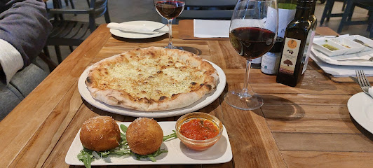 Corlie's Italian table with thin-crust pizza, arancini and red wine