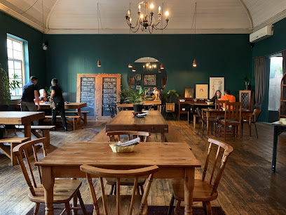 Bodega Ramen dining room with wooden tables and chalkboard menu