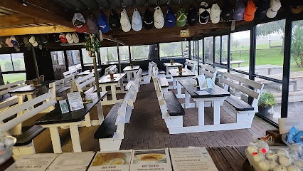 Wagner’s Golf Academy covered dining area with white picnic benches