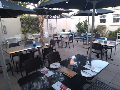 Blue Waters Seafood & Sushi outdoor patio with tables, umbrellas and place settings