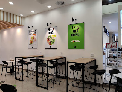 KAUAI Constantia seating with high tables, stools and posters 'SEOUL FOOD', 'LET'S GET GOING'.