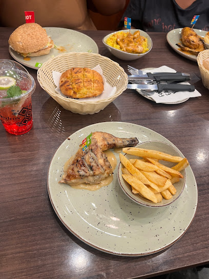 Pedro's Claremont grilled chicken quarter with fries and sides on table