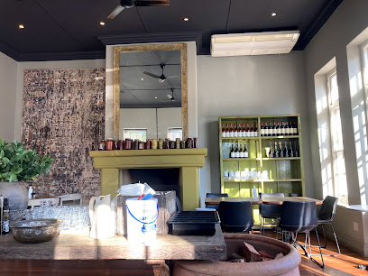 Kristen's Ice Cream Constantia cozy interior with green mantle, mirror and seating