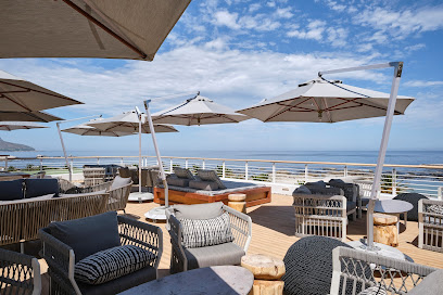 Baptiste Rooftop Bar lounge seating with umbrellas and ocean view