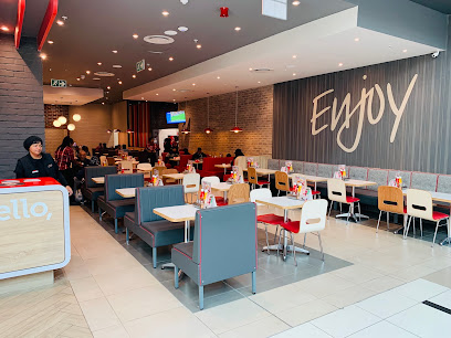 Wimpy Promenade dining area with booths and 'Enjoy' wall sign