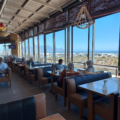 Golden Bay Spur dining room with ocean and Table Mountain views