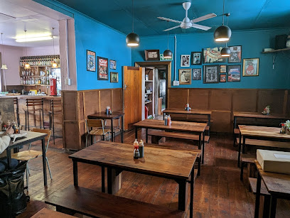 Downtown Ramen interior with wooden tables, blue walls, framed art