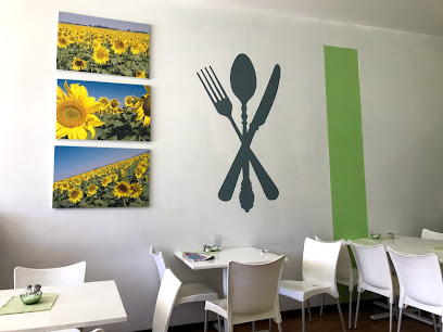 Sandi's Bistro dining area with sunflower wall art and cutlery mural
