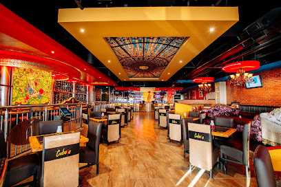 Cubana Tableview dining room with colorful stained-glass ceiling, booths and bar