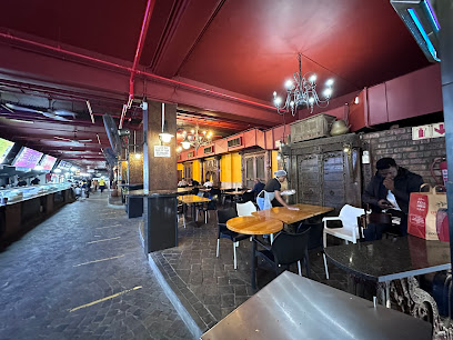 Eastern Food Bazaar interior with dining tables, food stalls and staff