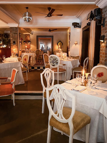 Duchess of Wisbeach dining room with candlelit tables and vintage chairs