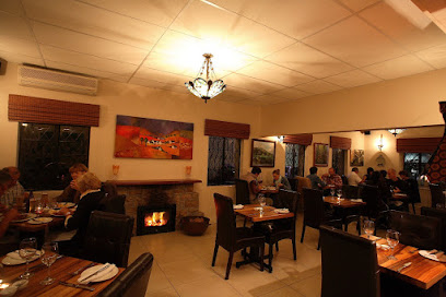 Warm dining room at Henri's Restaurant & Wine Bar with fireplace