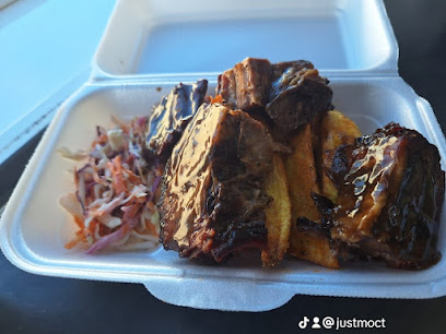 Just Mo's takeout box with glazed ribs, chips and coleslaw