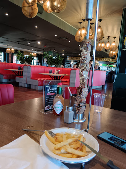 Dias Tavern interior with vertical grilled prawn skewer and fries