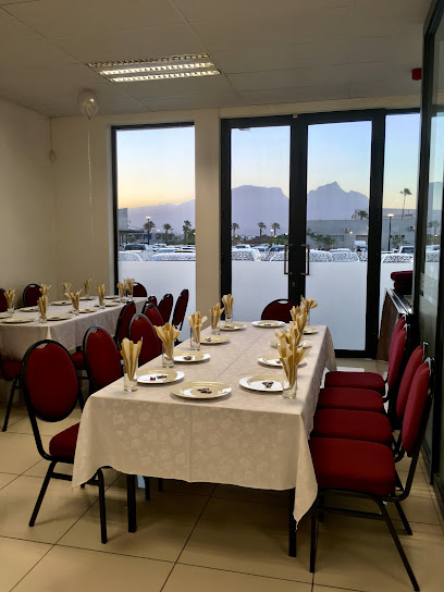 Gulshan Restaurant Coffee Lounge dining area set for service with table settings and mountain view