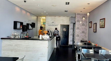 The Big Bay Waffle Company interior with counter, staff and seating