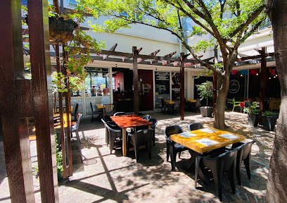 Shaded outdoor patio dining at The Smokey Brisket, Somerset West